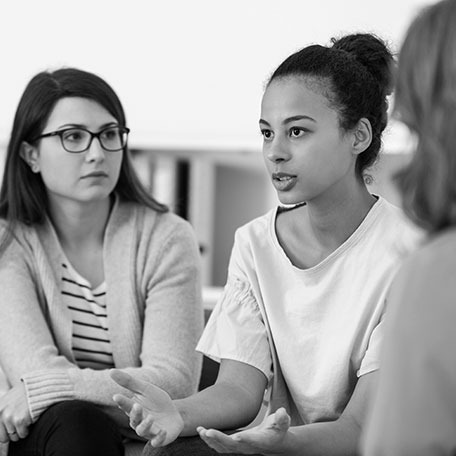 women supporting each other during psychotherapy group meeting